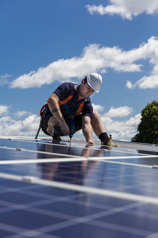 man working on solar panels